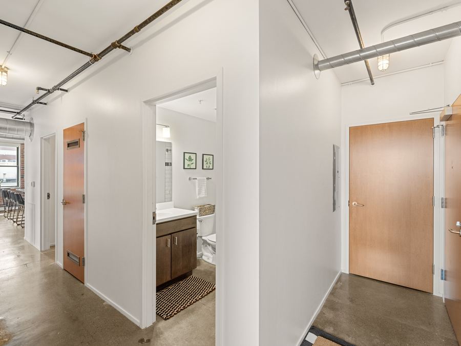 Harbach Lofts unit hallway with original wood doors and concrete floors