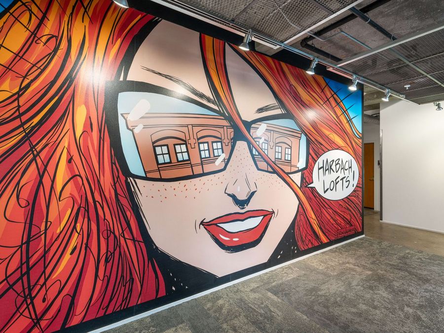 Hand-painted comic-style mural reading Harbach Lofts near the courtyard entrance